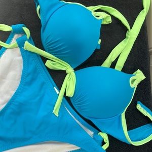 Brand new never worn side tie bikini. Bright turquoise with neon green trim.